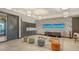 Inviting lounge area with modern furnishings, colorful wallpaper, TV, kitchenette, and comfortable seating at 10254 Morning Mist Ln, Sarasota, FL 34241