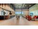 Bright lounge area featuring a bar, seating, a fireplace, and large windows at 10254 Morning Mist Ln, Sarasota, FL 34241