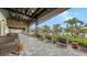 Relaxing outdoor patio featuring comfortable seating, lush landscaping, and views of the resort-style pool at 10254 Morning Mist Ln, Sarasota, FL 34241