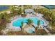 Aerial view of a community pool area featuring a pool, spa, lounge chairs and a covered patio with seating at 10254 Morning Mist Ln, Sarasota, FL 34241