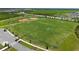 An aerial view of the community soccer fields with neatly manicured grass and soccer goals at 10254 Morning Mist Ln, Sarasota, FL 34241