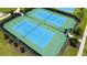 An aerial view of meticulously maintained community tennis courts with lush landscaping and a smooth, green walking path at 10254 Morning Mist Ln, Sarasota, FL 34241