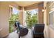 Relaxing balcony with comfortable seating, offering a peaceful outdoor retreat with lush green views at 1064 N Tamiami Trl # 1125, Sarasota, FL 34236