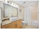 Bright bathroom with a vessel sink, granite counters, and a shower-tub combo at 1064 N Tamiami Trl # 1125, Sarasota, FL 34236