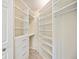 Spacious walk-in closet with custom shelving and drawers, offering plenty of room for storage at 1064 N Tamiami Trl # 1125, Sarasota, FL 34236
