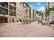 Spacious courtyard with tables, chairs, palm trees, and building views at 1064 N Tamiami Trl # 1125, Sarasota, FL 34236