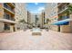 Beautiful courtyard featuring a fountain, seating, palm trees, and building views at 1064 N Tamiami Trl # 1125, Sarasota, FL 34236