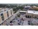 Exterior view of condo building and parking lot across from shops at 1064 N Tamiami Trl # 1125, Sarasota, FL 34236