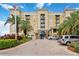 Beautiful building with palm trees and mature landscaping under a bright blue sky on a sunny day at 1064 N Tamiami Trl # 1125, Sarasota, FL 34236