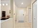 Hallway with coat closet, tile floors, and view into dining room at 1064 N Tamiami Trl # 1125, Sarasota, FL 34236