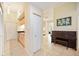 Hallway with tile floors, kitchen access, piano, and bright natural light at 1064 N Tamiami Trl # 1125, Sarasota, FL 34236