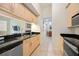 Bright kitchen features stainless steel appliances, black countertops, and light wood cabinets at 1064 N Tamiami Trl # 1125, Sarasota, FL 34236