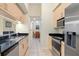 Bright kitchen features stainless steel appliances, black countertops, and light wood cabinets at 1064 N Tamiami Trl # 1125, Sarasota, FL 34236