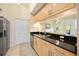 Bright kitchen features stainless steel appliances, black countertops, and light wood cabinets at 1064 N Tamiami Trl # 1125, Sarasota, FL 34236