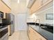 Modern kitchen featuring stainless steel appliances, granite countertops, and ample storage at 1064 N Tamiami Trl # 1125, Sarasota, FL 34236