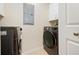 The Laundry room features modern washer and dryer units, as well as additional storage at 1064 N Tamiami Trl # 1125, Sarasota, FL 34236