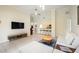 Bright living room boasts tile flooring, stylish bar stools, and an open layout leading into the kitchen at 1064 N Tamiami Trl # 1125, Sarasota, FL 34236