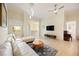 Cozy living room featuring tile floors, modern furnishings, and plenty of natural light from the window at 1064 N Tamiami Trl # 1125, Sarasota, FL 34236