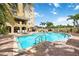 Community pool with comfortable lounge seating and building views at 1064 N Tamiami Trl # 1125, Sarasota, FL 34236