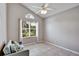 Bedroom with tile floors, a ceiling fan, and a large window with backyard view at 1112 Golfview Woods Dr # 1112, Sun City Center, FL 33573
