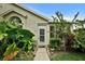 Charming front entrance with lush landscaping and a secure storm door at 1112 Golfview Woods Dr # 1112, Sun City Center, FL 33573