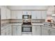 Kitchen features updated stainless steel appliances, granite countertops, and neutral-toned cabinetry at 1112 Golfview Woods Dr # 1112, Sun City Center, FL 33573