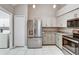 Bright kitchen with stainless steel appliances, light gray cabinets, and granite countertops at 1112 Golfview Woods Dr # 1112, Sun City Center, FL 33573