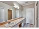 Main bath with double sinks, vanity, and a large mirror, providing ample space and convenience at 1112 Golfview Woods Dr # 1112, Sun City Center, FL 33573