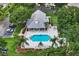 Aerial view of community pool area, surrounded by lounge chairs and lush greenery, creating a relaxing atmosphere at 1112 Golfview Woods Dr # 1112, Sun City Center, FL 33573