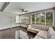 Enclosed sunroom with ceiling fan and many windows bringing the outside in at 1112 Golfview Woods Dr # 1112, Sun City Center, FL 33573