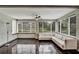 Bright sunroom with tiled floors, many windows with blinds, and comfortable seating at 1112 Golfview Woods Dr # 1112, Sun City Center, FL 33573