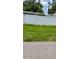 White fence with green grass on a sunny day at 11707 104Th St, Largo, FL 33773