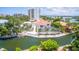 Beautiful aerial view of waterfront home with pool, dock, and access to the bay in a tropical setting at 1240 Solitude Ln, Sarasota, FL 34242