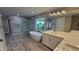 Luxurious bathroom featuring a soaking tub, glass shower, and dual vanities with elegant finishes at 1240 Solitude Ln, Sarasota, FL 34242