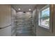 Updated bathroom showcasing a glass-enclosed shower with stylish tilework and modern fixtures at 1240 Solitude Ln, Sarasota, FL 34242