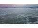 Inviting beach with gentle waves and a stunning sunset sky at 1240 Solitude Ln, Sarasota, FL 34242
