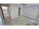 Open bedroom with wood-look flooring and an interior doorway leading to the kitchen at 1240 Solitude Ln, Sarasota, FL 34242