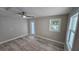 Bright, updated bedroom with wood-look flooring, a ceiling fan, and natural light from the window at 1240 Solitude Ln, Sarasota, FL 34242