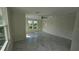 A bright bedroom with marble-patterned tile floor and natural light streaming through the windows at 1240 Solitude Ln, Sarasota, FL 34242