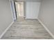 Neutral bedroom showing wood-look floors, trim, and a closet at 1240 Solitude Ln, Sarasota, FL 34242
