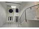 Elegant entryway featuring high ceilings, decorative windows, and a modern staircase with a metal railing at 1240 Solitude Ln, Sarasota, FL 34242