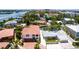 Charming waterfront home with a red tile roof, mature trees, and lush landscaping at 1240 Solitude Ln, Sarasota, FL 34242