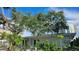 Charming single-story home with lush landscaping, mature trees, and a freshly painted exterior at 1240 Solitude Ln, Sarasota, FL 34242