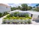 Charming home featuring manicured landscaping, a white picket fence, and well-maintained yard at 1240 Solitude Ln, Sarasota, FL 34242
