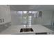Modern kitchen featuring sleek countertops, stainless steel appliances, and contemporary lighting at 1240 Solitude Ln, Sarasota, FL 34242