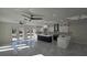 Open-concept kitchen with white cabinetry, an island, and marble-patterned tile flooring at 1240 Solitude Ln, Sarasota, FL 34242
