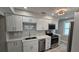 Updated kitchen featuring modern white cabinets, stainless steel appliances, and tile backsplash at 1240 Solitude Ln, Sarasota, FL 34242