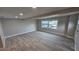 Spacious living room featuring hardwood floors and a large window for ample natural light at 1240 Solitude Ln, Sarasota, FL 34242