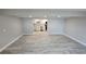 Bright living room with hardwood floors leading to a modern kitchen with white cabinets at 1240 Solitude Ln, Sarasota, FL 34242