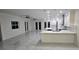 Spacious living room with an open layout, connecting to a modern kitchen and offering a view of the outdoor patio at 1240 Solitude Ln, Sarasota, FL 34242